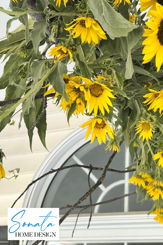 A Sunflower and foraged tree branch decor idea for the porch.