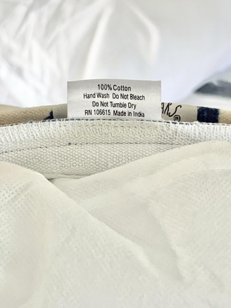 The care tag inside a pillow cover tells us How to Clean Throw Pillows.