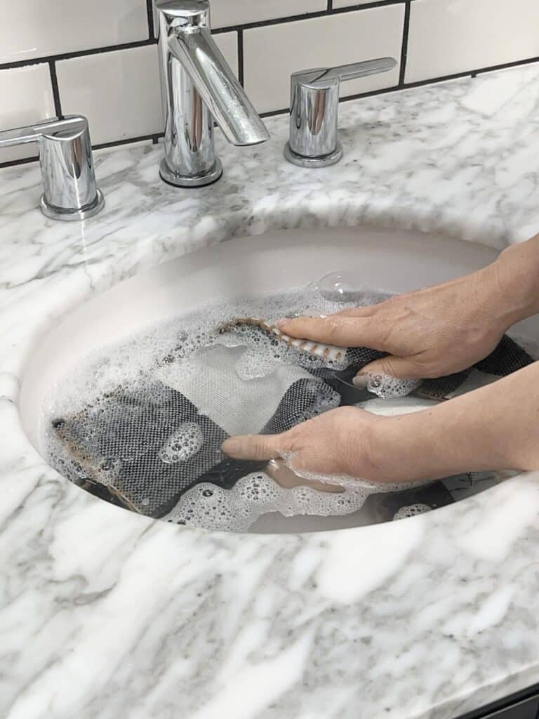 Hand washing a pillow cover.