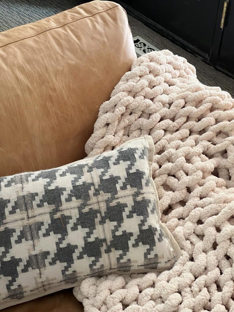 fall living room decorating ideas include a large loop throw blanket and a houndstooth pillow.