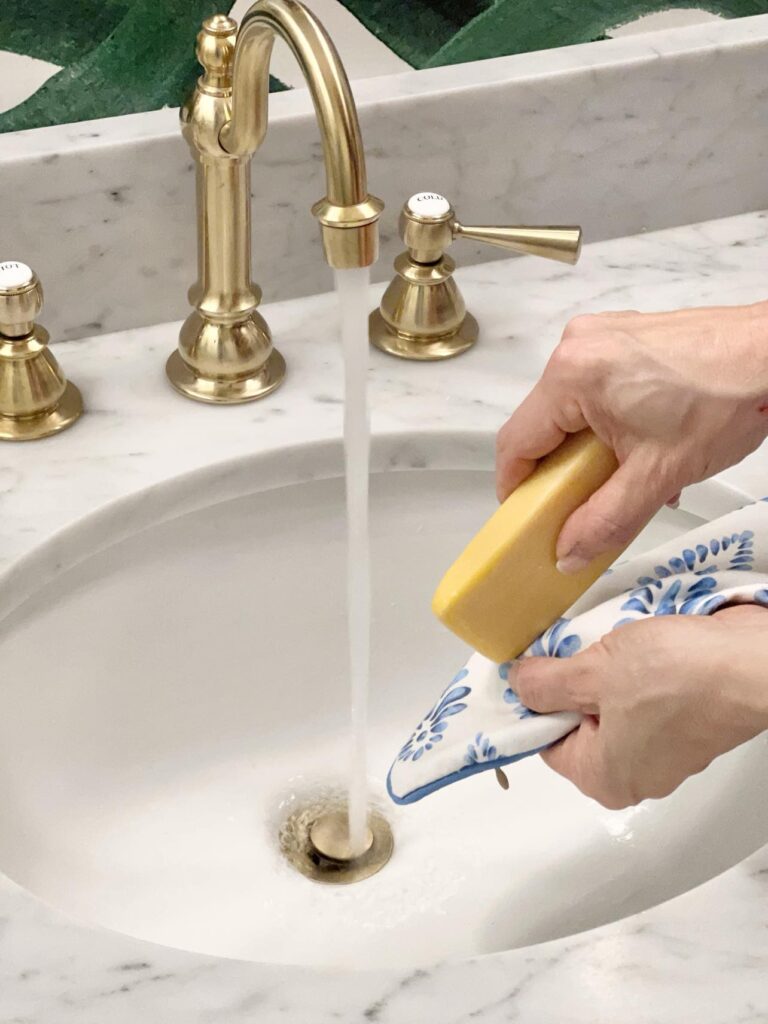 Spot cleaning a pillow cover with a bar of soap.