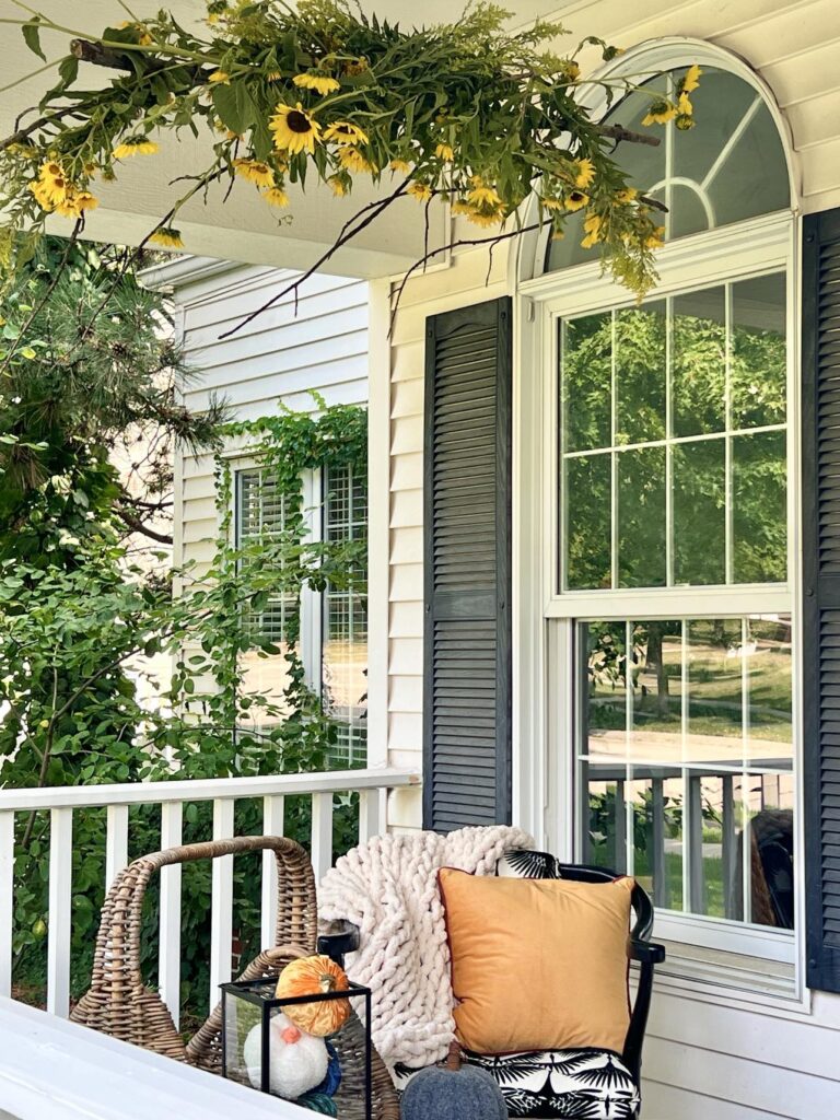 A seating area on the porch for tree branch decor ideas.