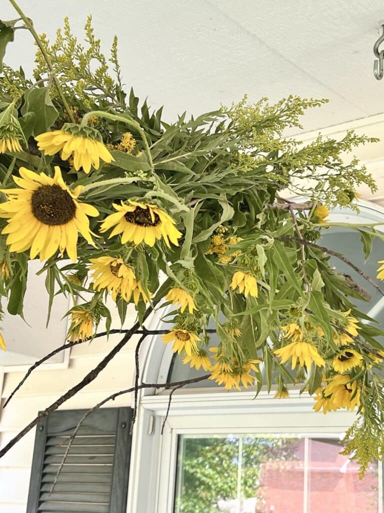 Hanging branches and flowers on the porch.