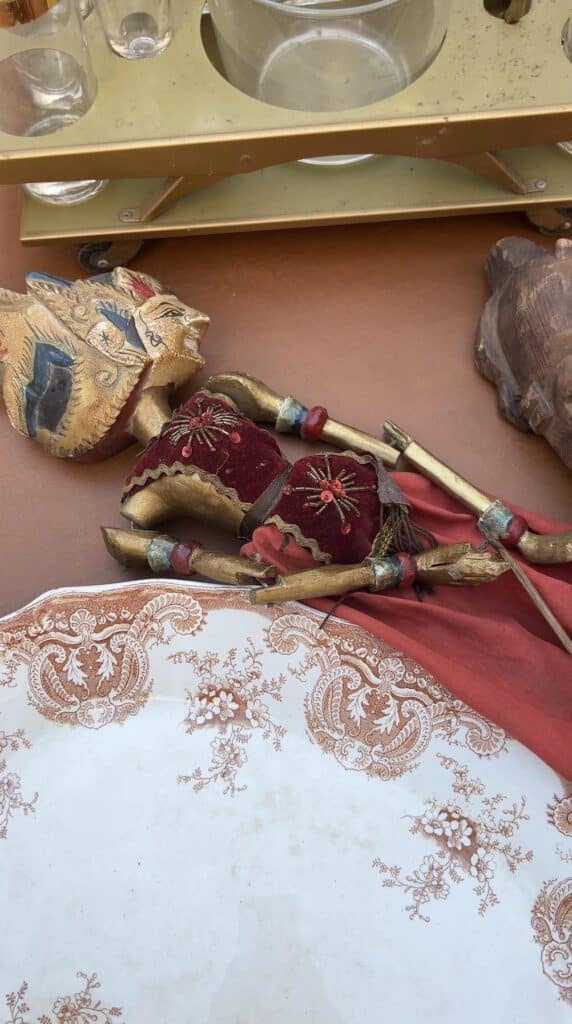 A rod puppet sitting on a vendor table at the chelsea flea market manhattan New York.