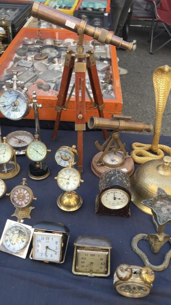 Table of antique clocks at chelsea flea market manhattan.