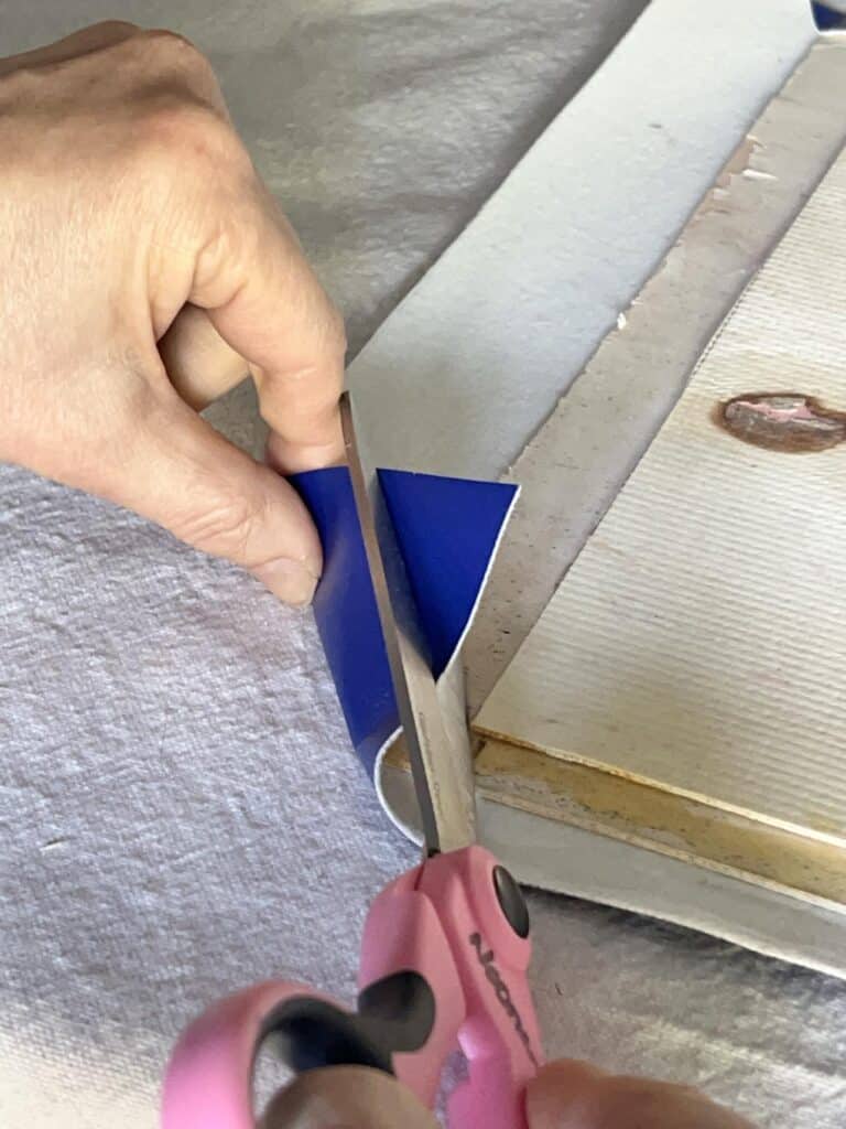 Cutting the corner of a piece of faux leather.