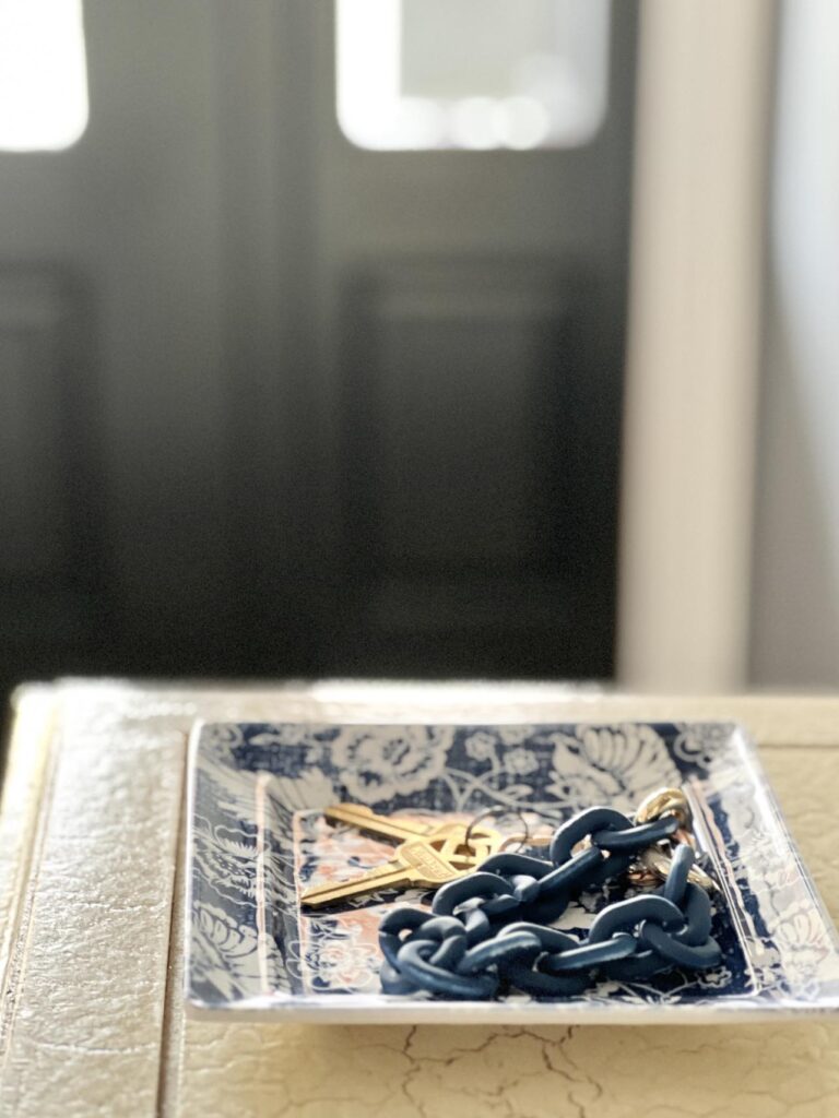 A set of keys sitting on a blue and white plate.