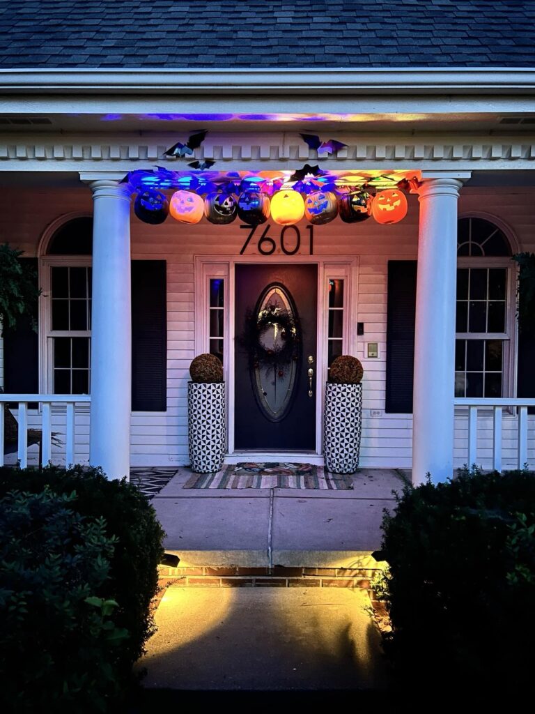 Illuminated pumpkin pail porch decorations.