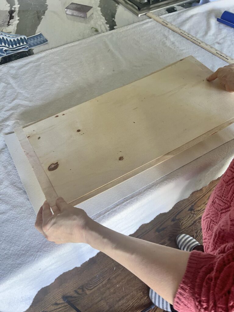 Centering MDF board on the back of a piece of faux leather for a diy desk pad.