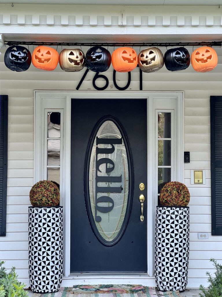 Pumpkin porch decorations hanging on top of front porch door.