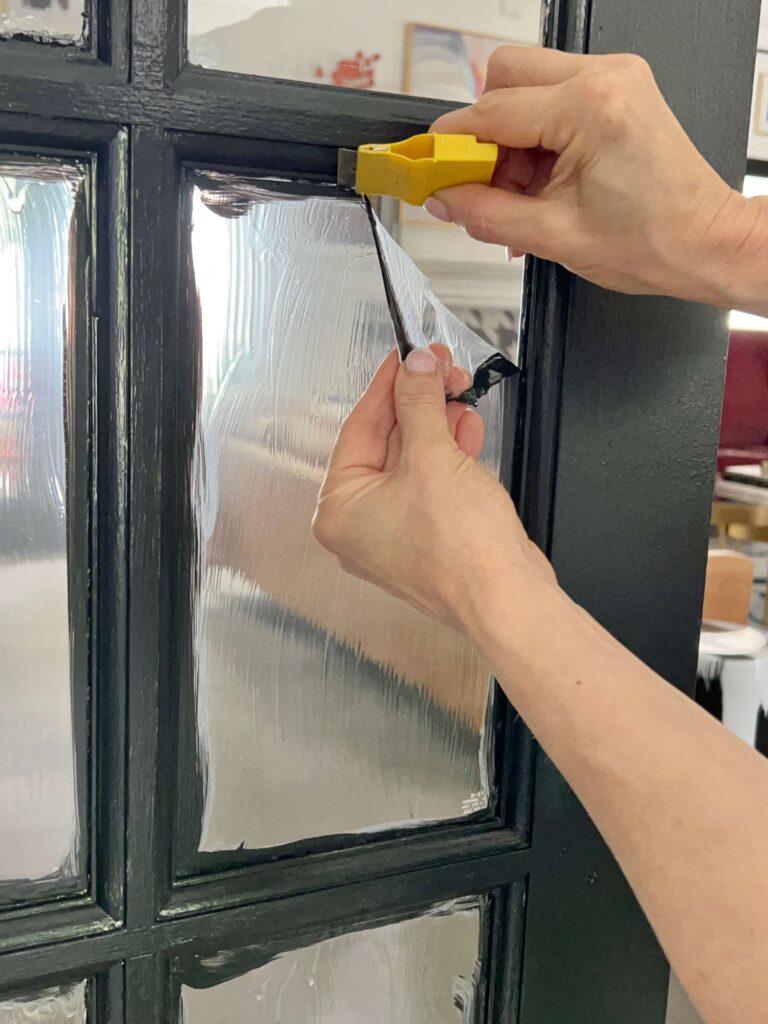 Removing liquid mask peel from French door window panes.