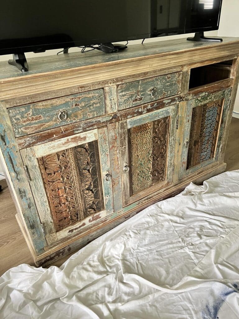 A faded furniture console table that will be painted.