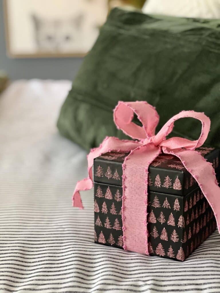 A giftbox wrapped in pink ribbon.