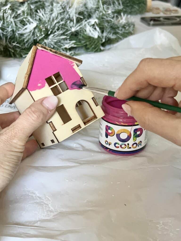 Paint a tiny wood wood pink for an Anthropologie DIY Christmas Wreath.