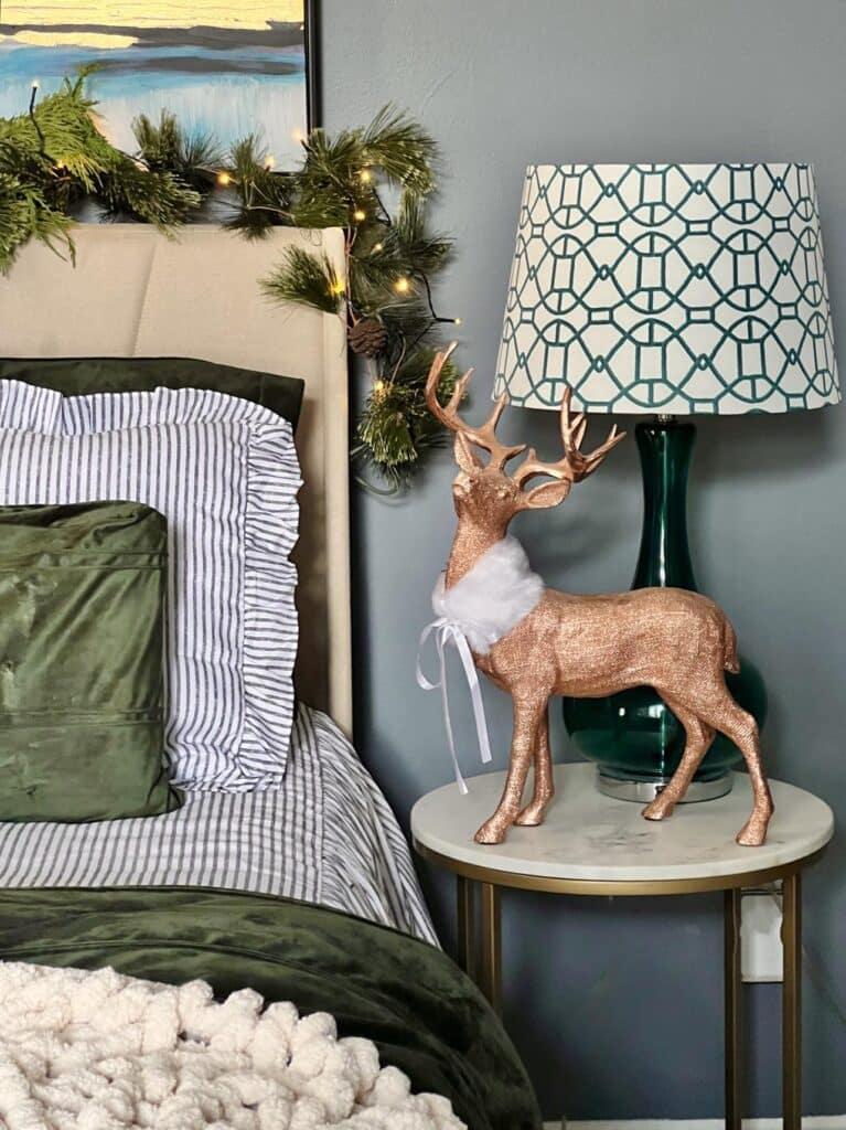 A reindeer decor piece sitting on a nightstand in the Christmas bedroom