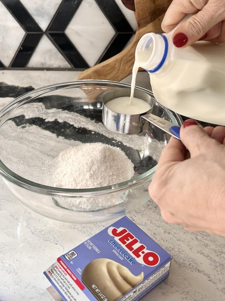 Adding milk to instant cheesecake mix for pudding shots.