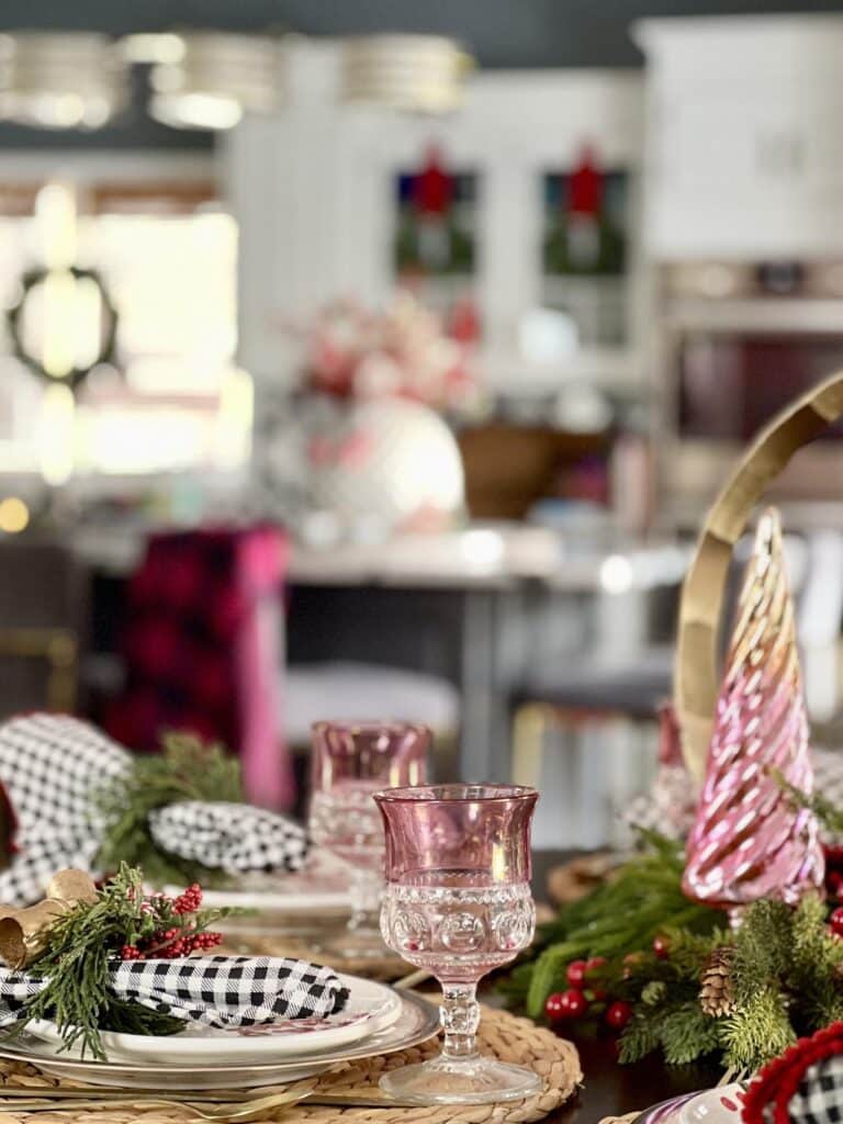 A blush pink glass goblet on a placemat for a holiday home tour tablescape.