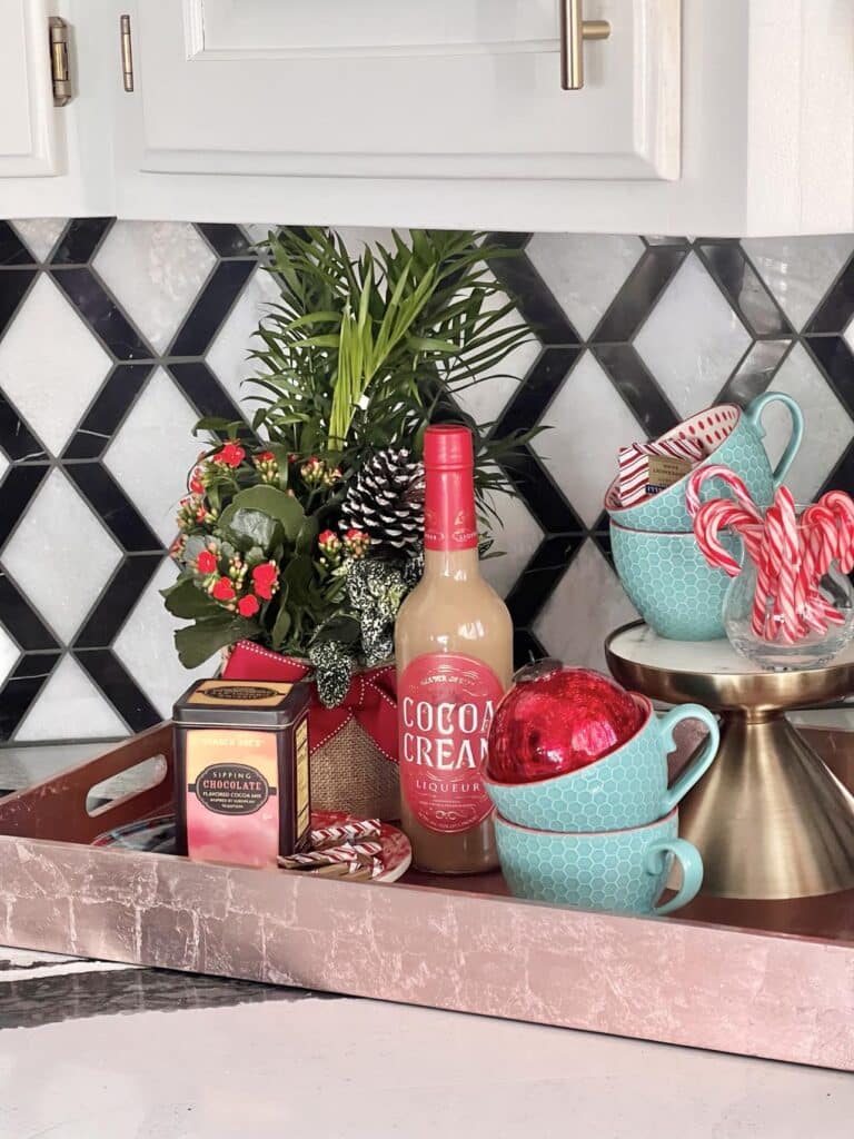 A tray filled with cups and cocoa for a holiday home tour.