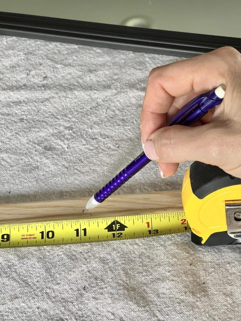 Marking wood molding with a pencil.