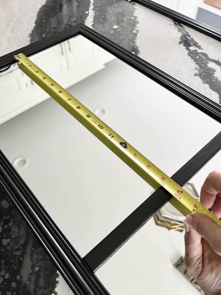 Measuring the length of the glass in a mirror.