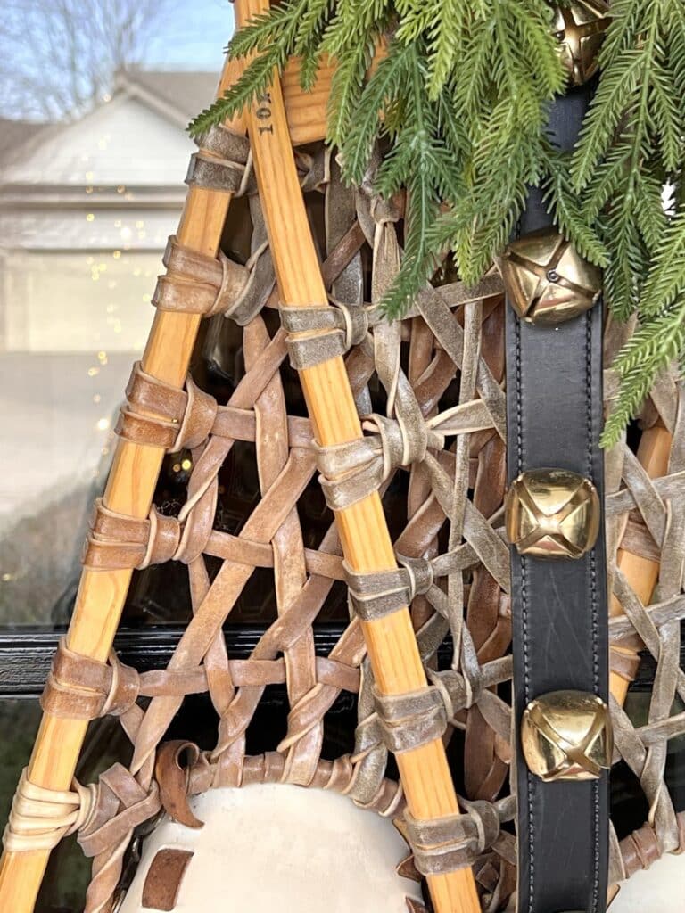 Decorating with snowshoes with attached jingle bells and greenery.