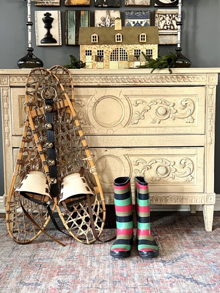 Snowshoes propped on a front entry table as a means of decorating for winter.