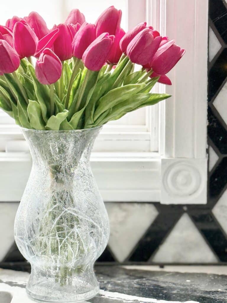 Pink flowers in a crackled glass DIY vase after completing a simple how to project.