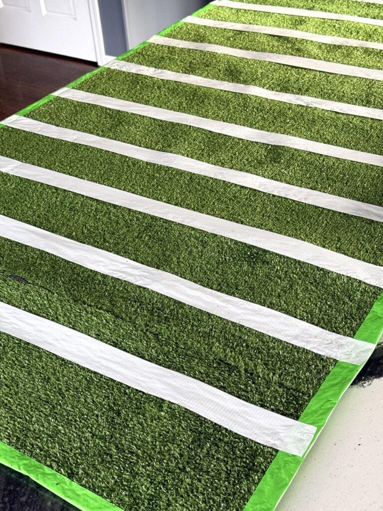 White duct tape on a sheet of artificial turf.