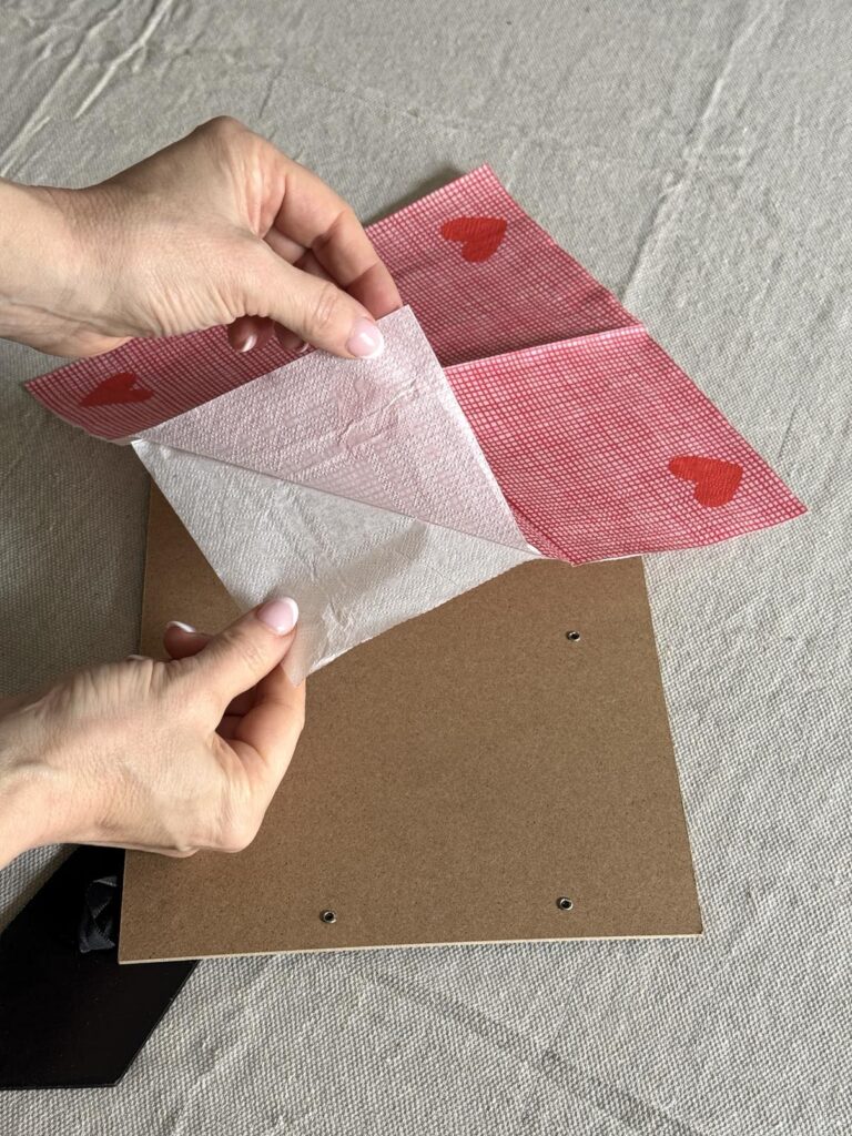 Separating the sheets of a paper napkin.