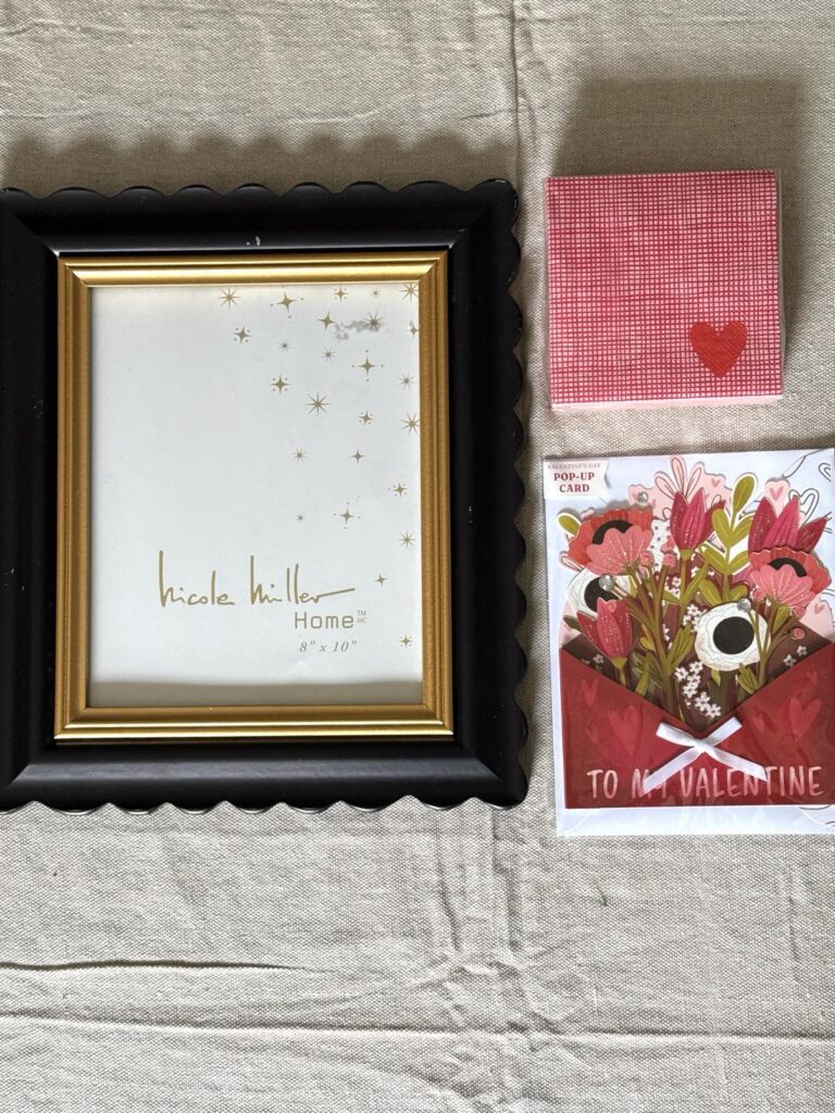 A picture frame, heart-themed paper napkins, and a 3d paper Valentine.