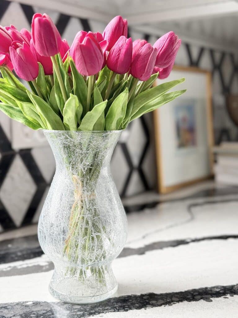 Flowers in a vase on a countertop.