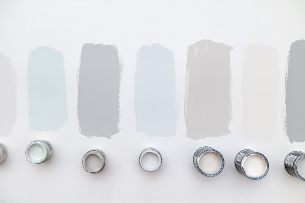 Testing paint swatches on a wall to avoid decorating mistakes with color.