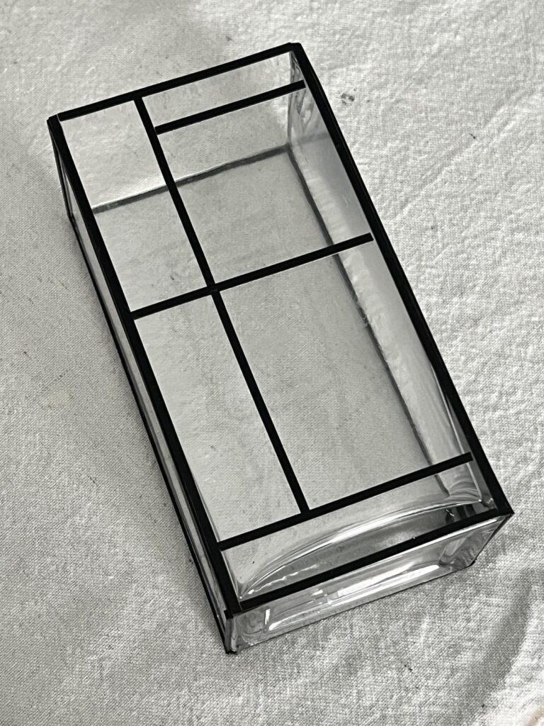 Lead lines applied to a glass vase for paint.