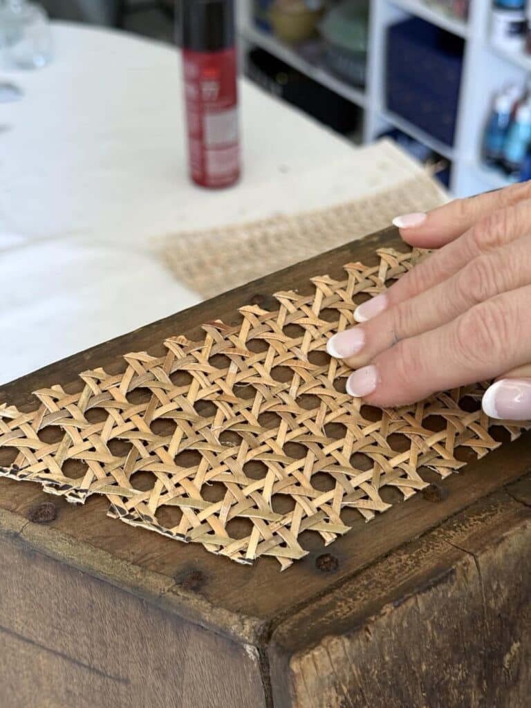 Pressing rattan onto the side of a wood garden tote.