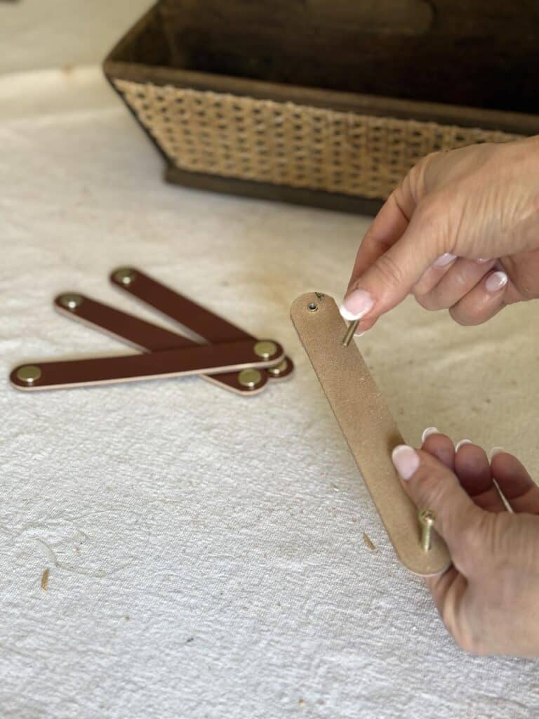 Brown leather drawer pulls.