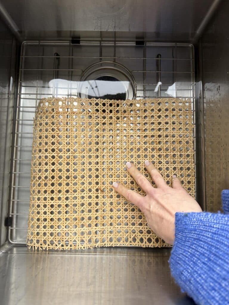 Soaking a sheet of rattan in water.